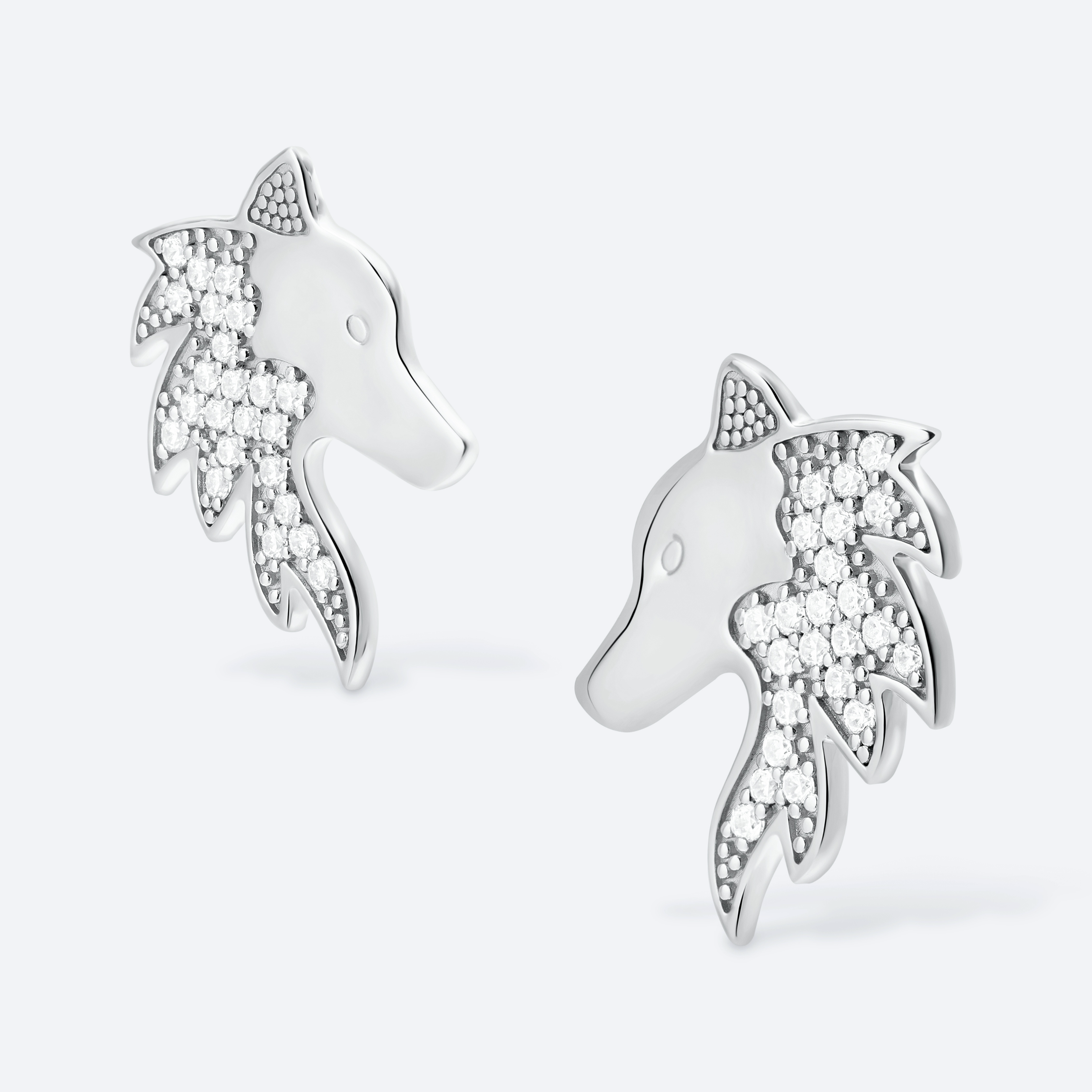 Silver horse-shaped earrings with embedded stones on a white background