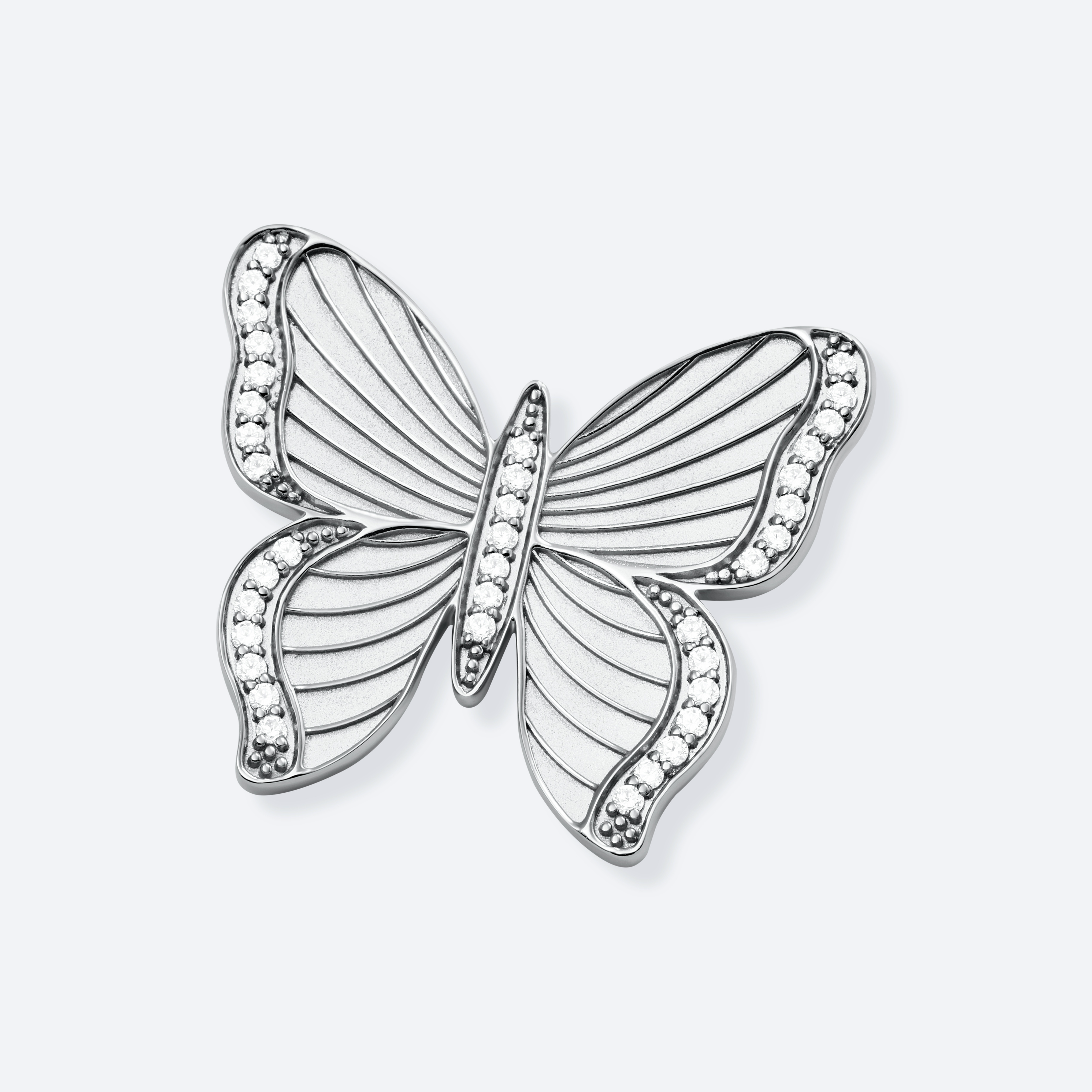 Silver butterfly-shaped pendant with gemstones on a light gray background