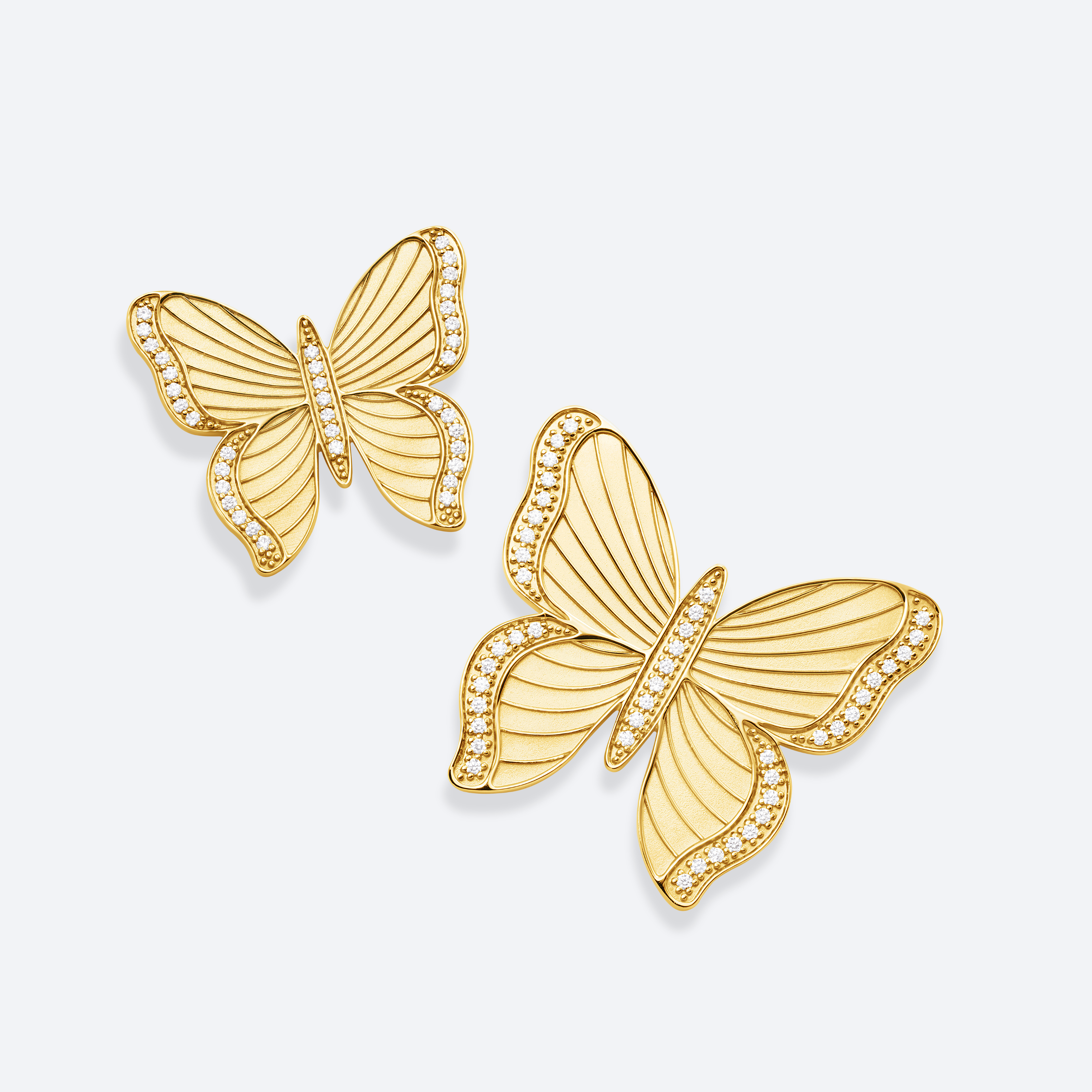 Gold butterfly earrings on a light gray background